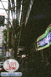 Hong-Kong-bamboo-scaffolding-neon-sign-pedestrians-on-pavement-SB